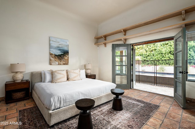 bedroom featuring beamed ceiling, access to exterior, and multiple windows