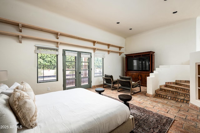 bedroom featuring recessed lighting, access to outside, french doors, and brick floor