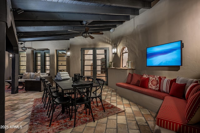 dining room with beamed ceiling, ceiling fan, brick floor, and french doors