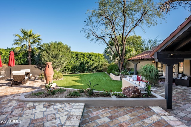 view of yard featuring an outdoor living space, fence, and a patio area