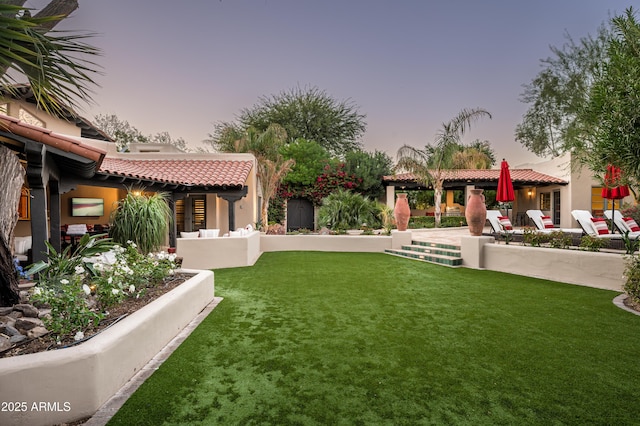 yard at dusk featuring a patio and a gazebo