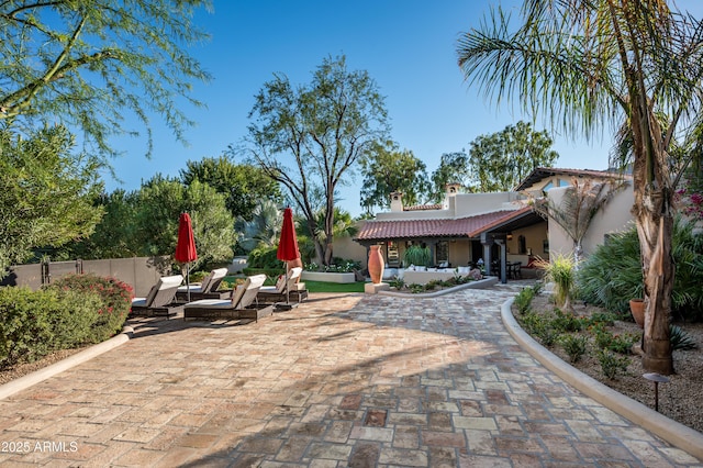 surrounding community featuring fence and a patio area