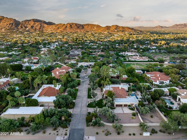 aerial view at dusk featuring a mountain view