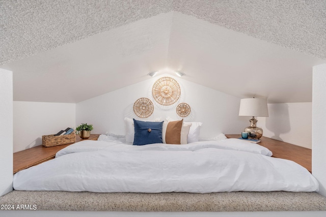 bedroom featuring vaulted ceiling and wood finished floors