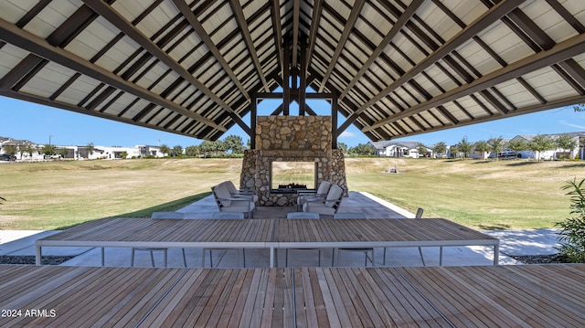 deck with a yard, a patio, and an outdoor stone fireplace