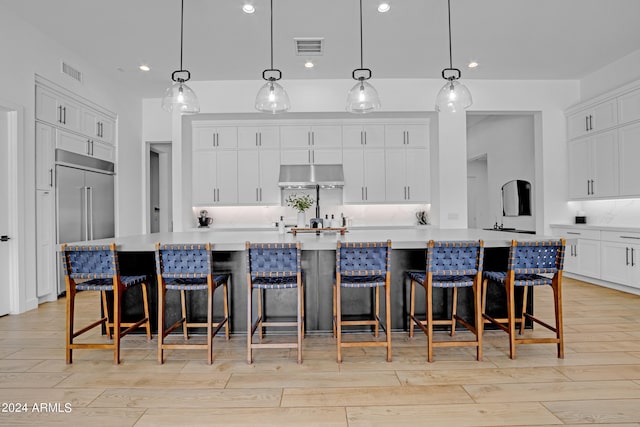 kitchen featuring hanging light fixtures, a large island, and light hardwood / wood-style flooring