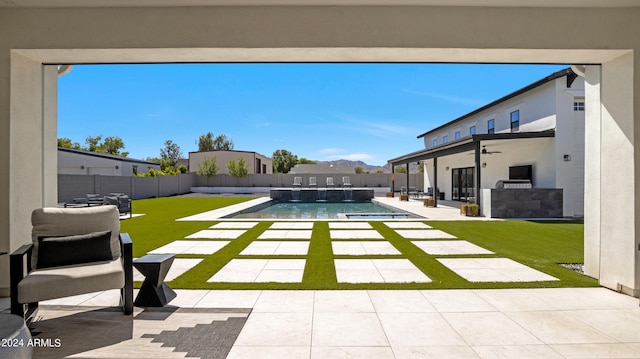 view of yard with a fenced in pool and a patio