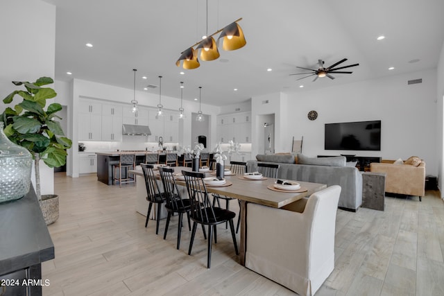 dining space with ceiling fan and light hardwood / wood-style floors