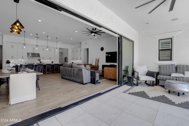 living room featuring ceiling fan and light wood-type flooring