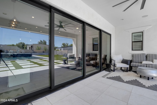 doorway to outside featuring ceiling fan and light tile patterned flooring