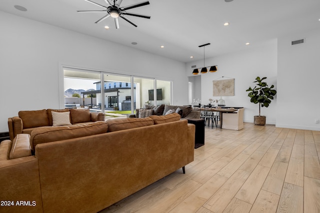 living room featuring ceiling fan and light hardwood / wood-style floors