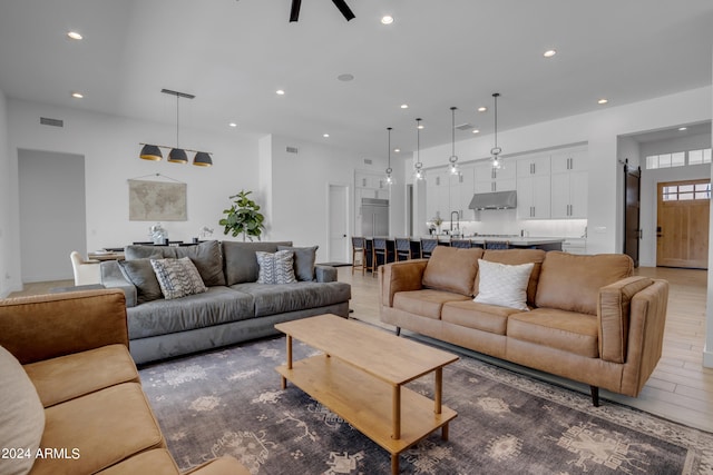 living room with wood-type flooring and ceiling fan