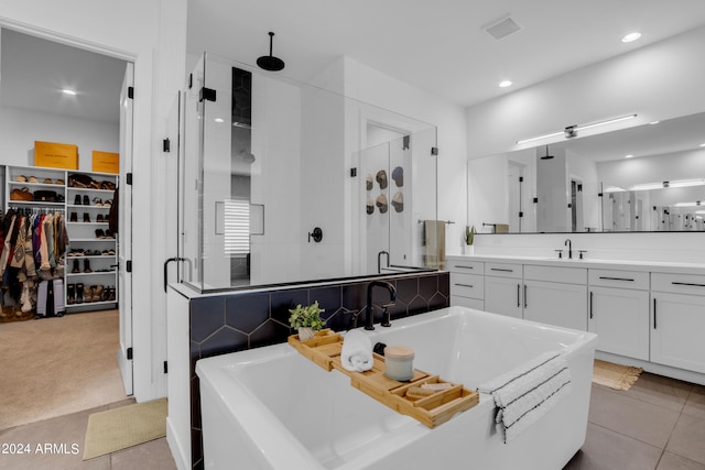 kitchen featuring white cabinets, light tile patterned floors, and sink