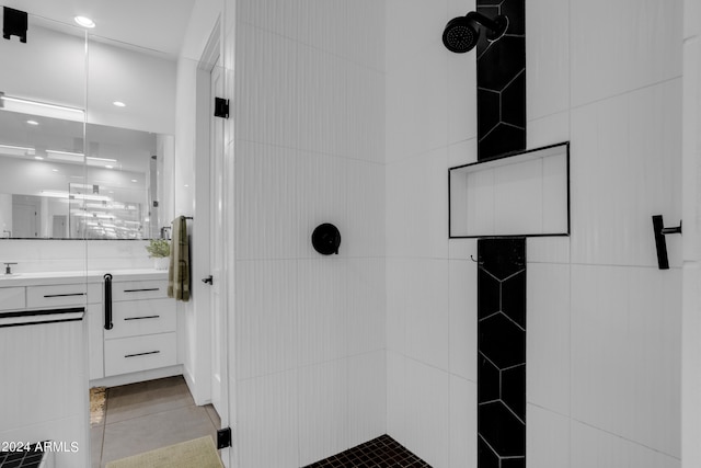 bathroom with a shower, vanity, and tile patterned floors