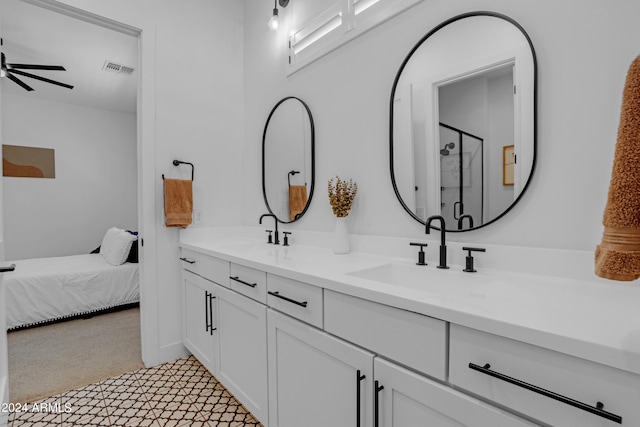 bathroom featuring walk in shower, vanity, and ceiling fan