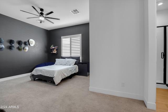 bedroom with light carpet and ceiling fan