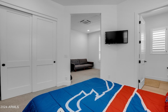 carpeted bedroom featuring a closet