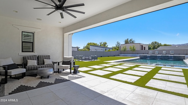 view of patio / terrace featuring pool water feature, a fenced in pool, and ceiling fan