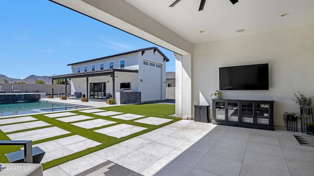 exterior space with a patio, a fenced in pool, a mountain view, and pool water feature