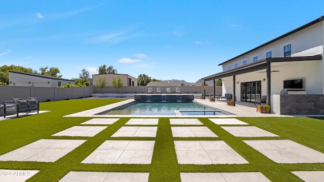 view of swimming pool featuring a yard and a patio area