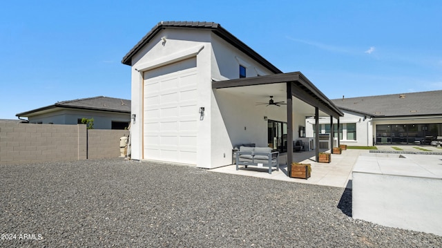 back of property featuring ceiling fan and a patio area