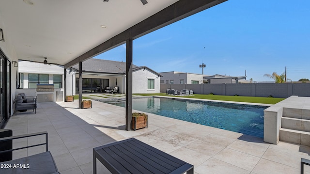 view of pool featuring ceiling fan and a patio area