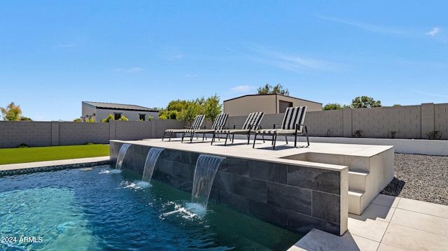 view of swimming pool with a patio and pool water feature