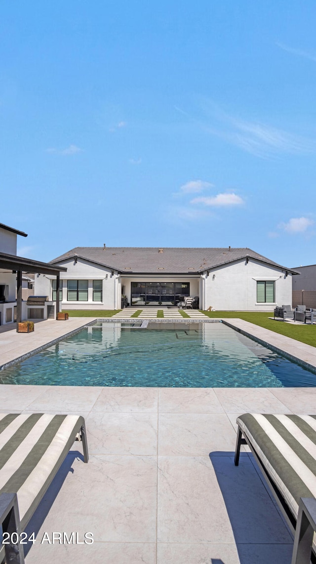 view of swimming pool with a patio