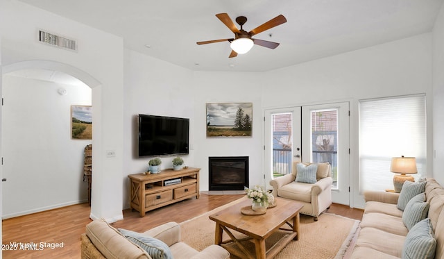 living room with french doors, ceiling fan, and light hardwood / wood-style flooring