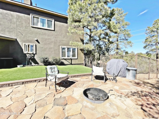 view of patio with fence and a grill