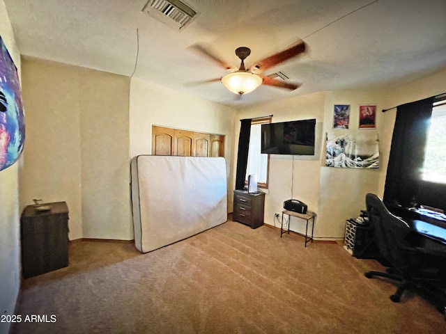 bedroom with light carpet, ceiling fan, and visible vents