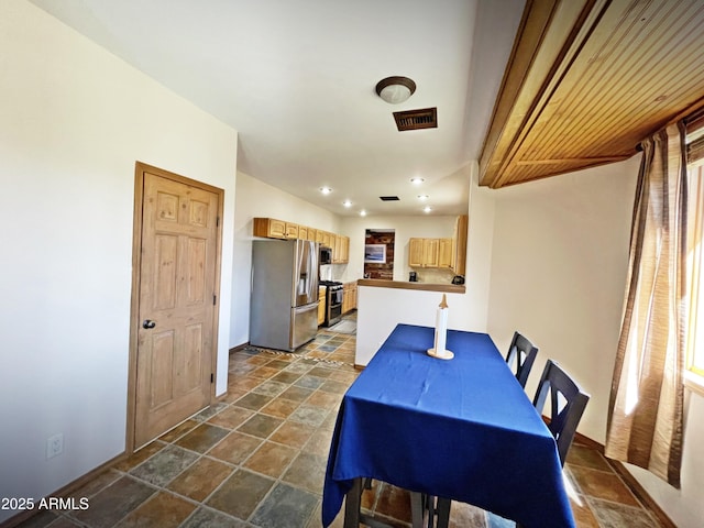 dining area with recessed lighting, stone finish flooring, and visible vents