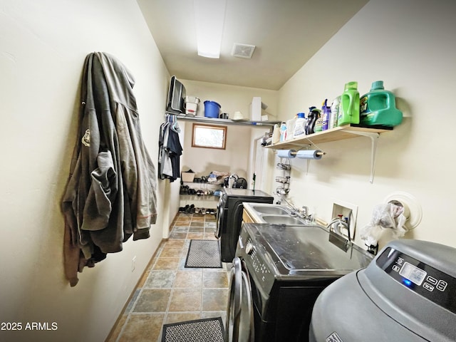 clothes washing area featuring laundry area, visible vents, and independent washer and dryer