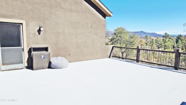 view of patio featuring a mountain view and a balcony