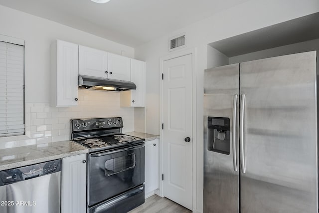 kitchen featuring stainless steel appliances, under cabinet range hood, white cabinetry, and light stone counters