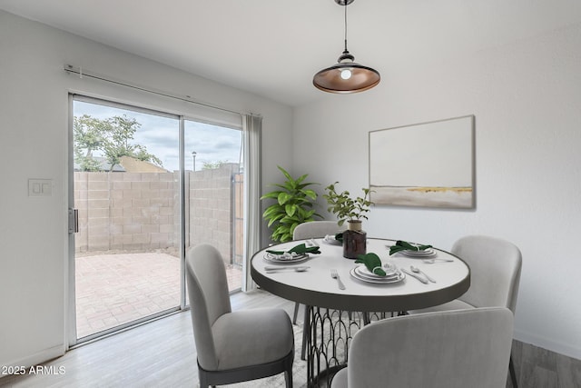 dining room featuring wood finished floors and baseboards