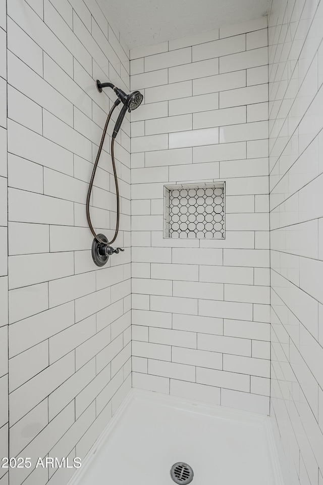 full bath featuring tiled shower