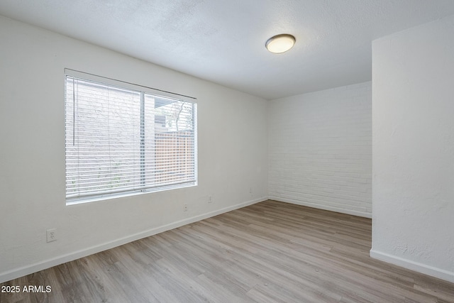 unfurnished room featuring wood finished floors and baseboards