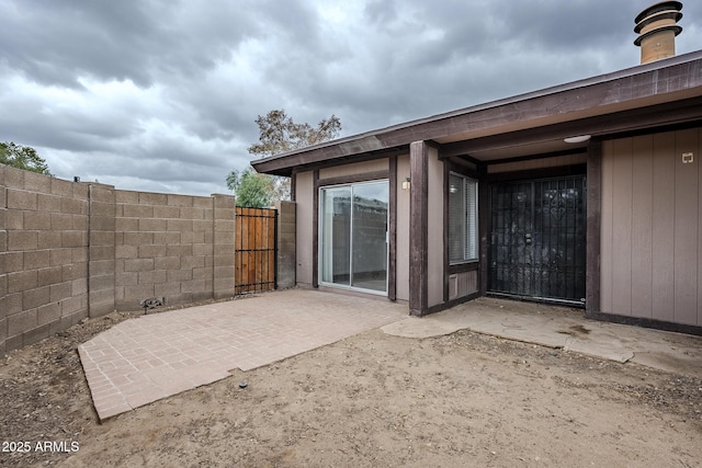 view of patio / terrace featuring fence and a gate