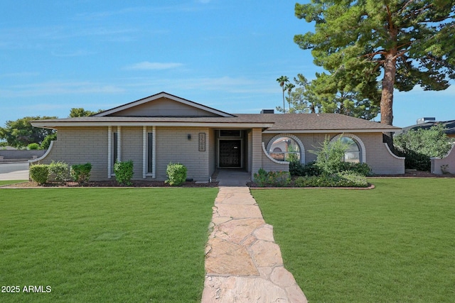 ranch-style house with brick siding and a front lawn