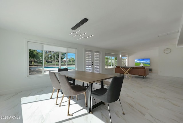 dining area with marble finish floor, french doors, and baseboards