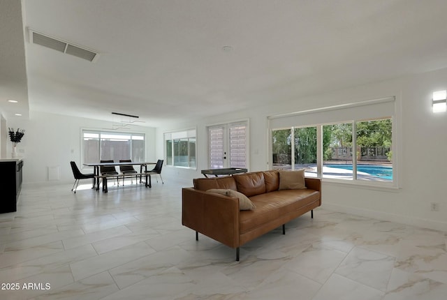 living room with marble finish floor, visible vents, and baseboards