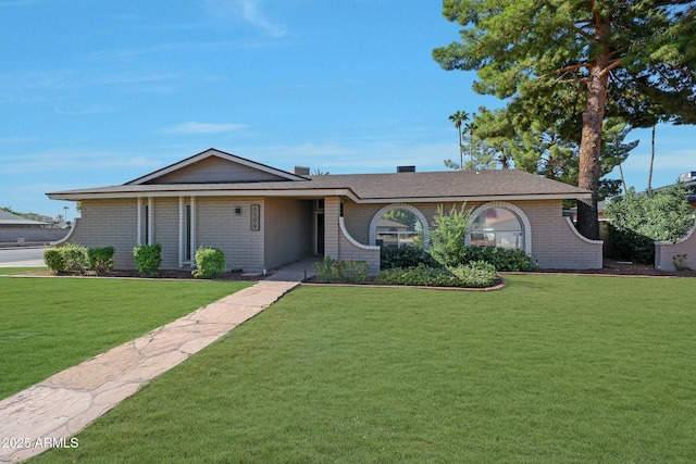 single story home with brick siding and a front lawn