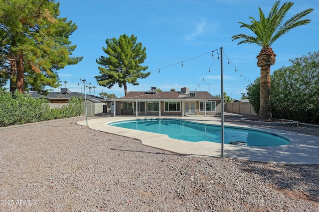 pool featuring a patio and fence