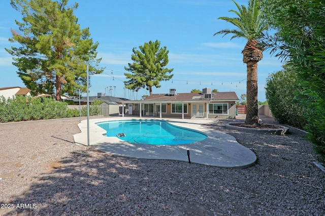 view of swimming pool featuring a fenced in pool, a patio area, and fence