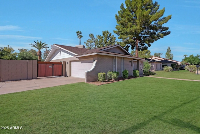 view of front of property featuring driveway, an attached garage, fence, and a front yard