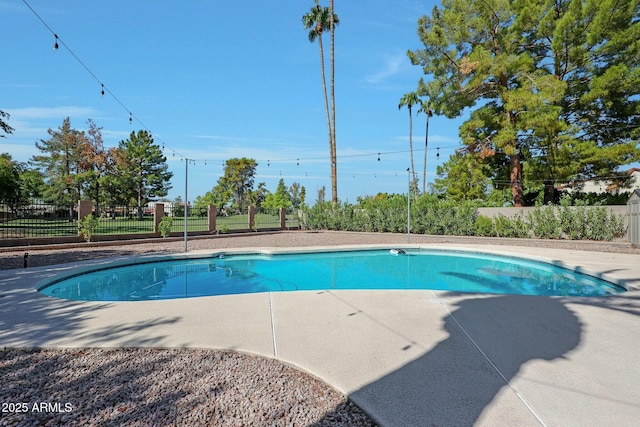 view of swimming pool featuring fence and a fenced in pool