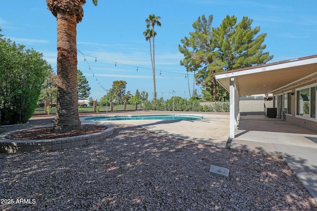 view of pool featuring fence, a fenced in pool, and a patio