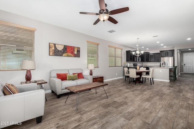 living area featuring recessed lighting, wood finished floors, visible vents, and baseboards