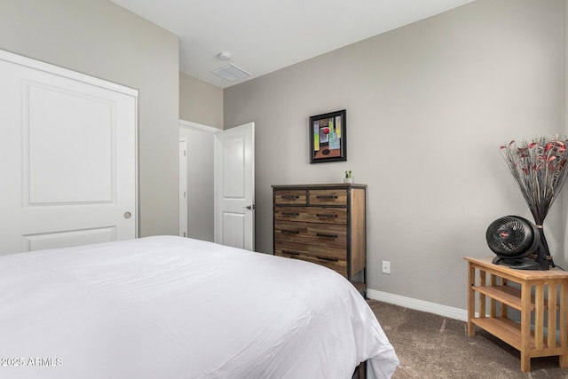 bedroom with dark colored carpet, visible vents, and baseboards